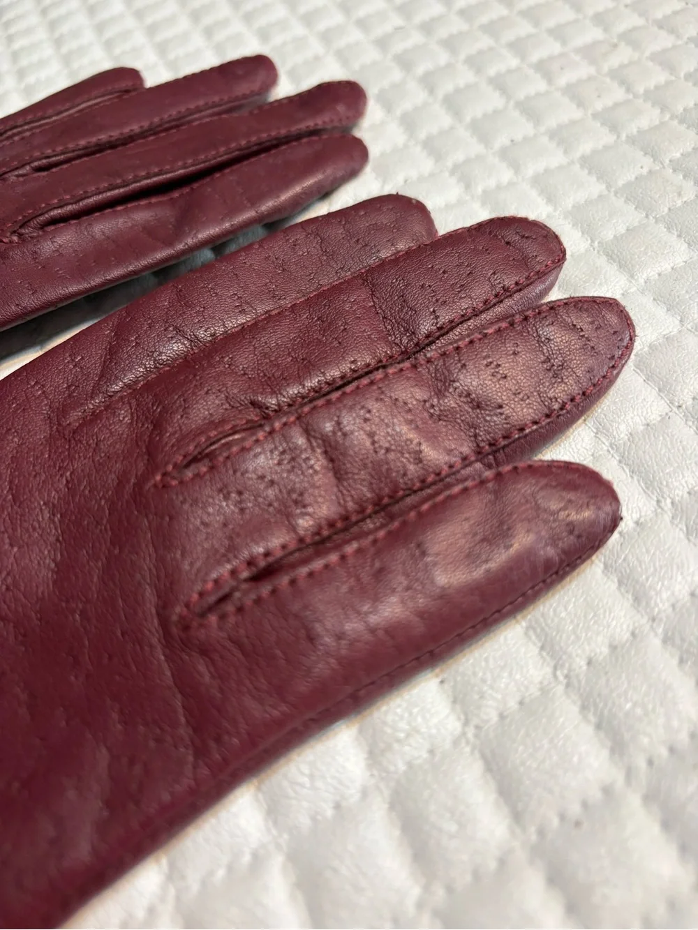 maroon leather gloves feature a distinctive textured perforated pattern 6.5
